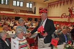 Presentation of a gift to a member who traveled the greatest distance.