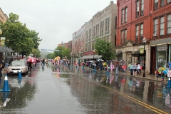 Balloons for sale and people in the rain waiting for the parade to come along.